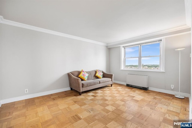 sitting room featuring crown molding, radiator, and light parquet floors