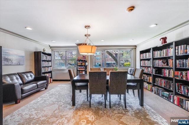 dining room with crown molding, carpet, and a healthy amount of sunlight