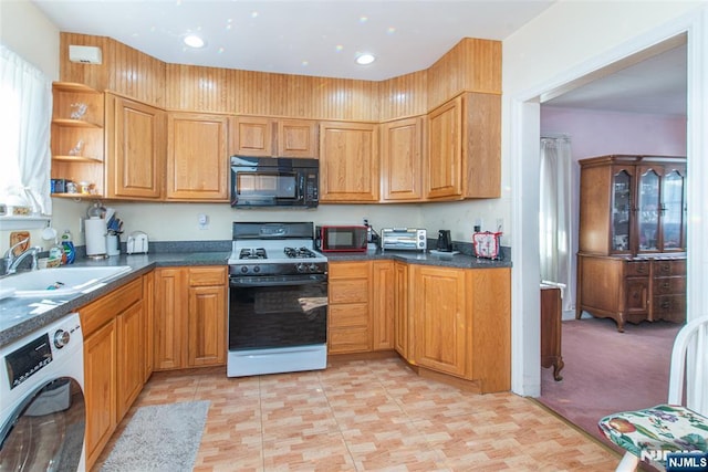 kitchen with gas range, light colored carpet, dishwashing machine, and sink