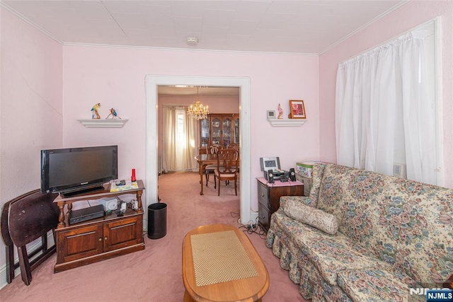 carpeted living room with crown molding and a chandelier