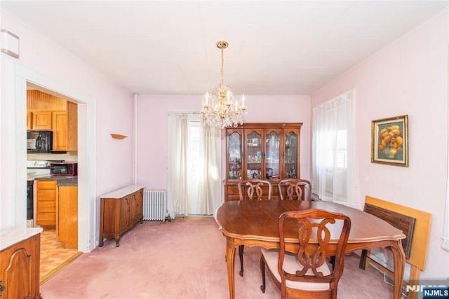 dining area with a healthy amount of sunlight, radiator heating unit, a chandelier, and light carpet