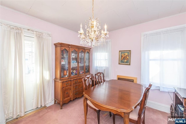 dining space with plenty of natural light, carpet floors, and a notable chandelier