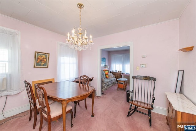 carpeted dining room with a notable chandelier and a wealth of natural light