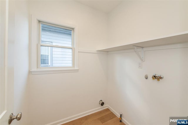 washroom with gas dryer hookup, washer hookup, and wood-type flooring