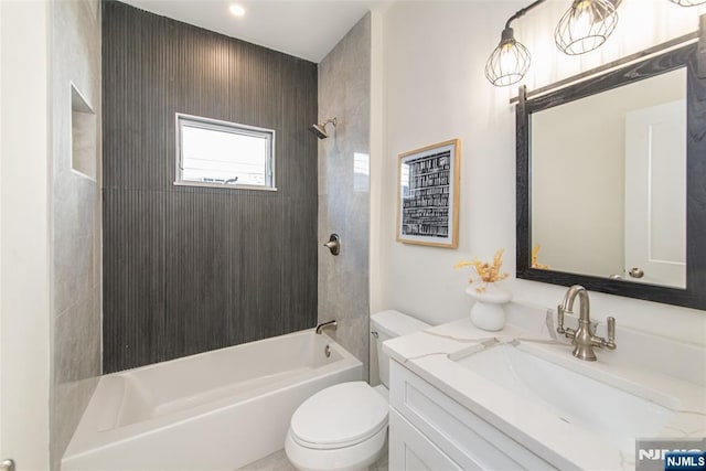 full bathroom featuring vanity, toilet, and tiled shower / bath