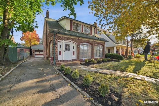 view of front facade with a garage and a front lawn