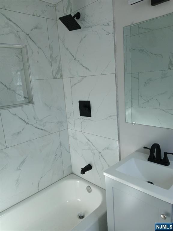 bathroom featuring vanity and tiled shower / bath combo