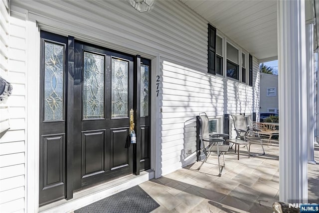 property entrance with covered porch