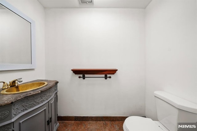 bathroom with vanity and toilet