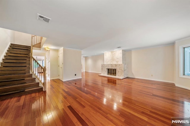 unfurnished living room with hardwood / wood-style flooring and a fireplace