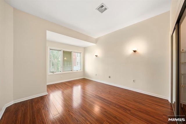 spare room featuring wood-type flooring