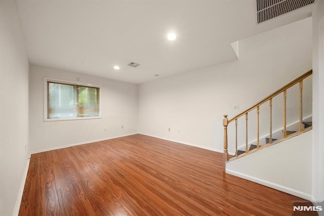 unfurnished room with hardwood / wood-style flooring