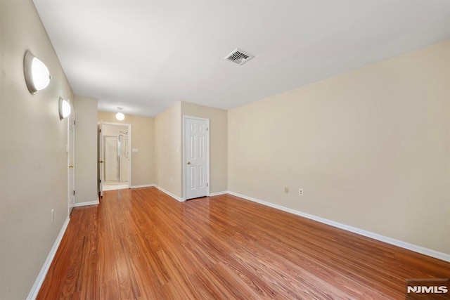 unfurnished room with light hardwood / wood-style flooring