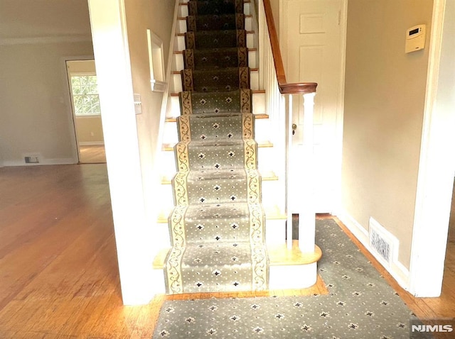 stairs featuring hardwood / wood-style flooring