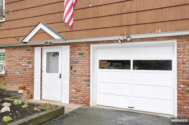 view of exterior entry with a garage