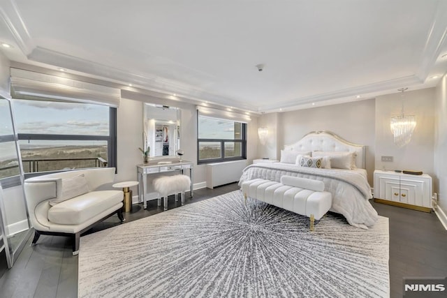 bedroom featuring dark hardwood / wood-style floors and a chandelier