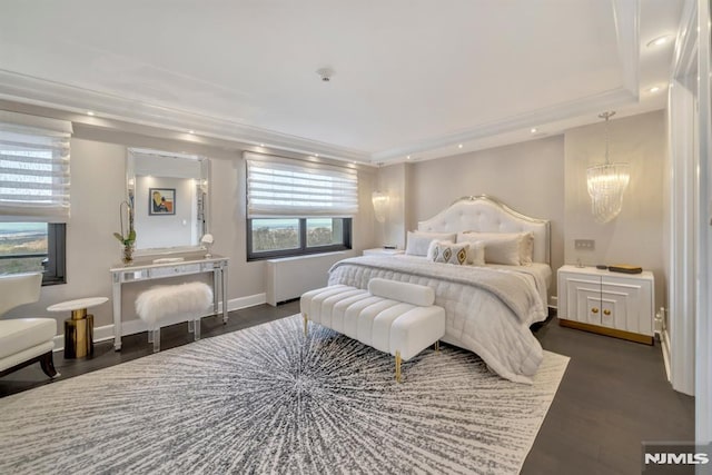 bedroom featuring dark hardwood / wood-style floors and an inviting chandelier