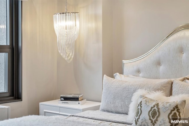 bedroom featuring an inviting chandelier