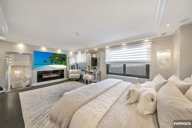 bedroom with hardwood / wood-style flooring and a chandelier