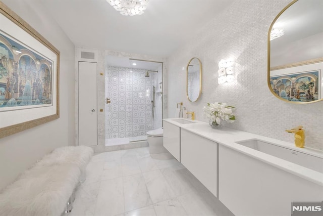 bathroom featuring vanity, tile walls, toilet, and tiled shower