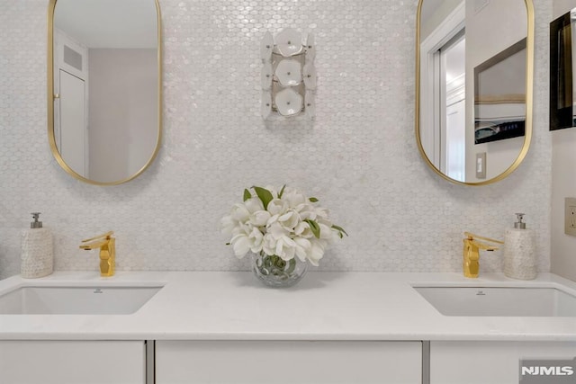 bathroom with tasteful backsplash and vanity