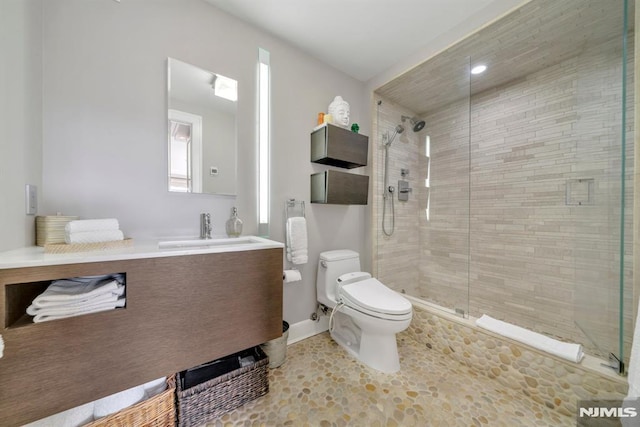 bathroom with vanity, an enclosed shower, and toilet