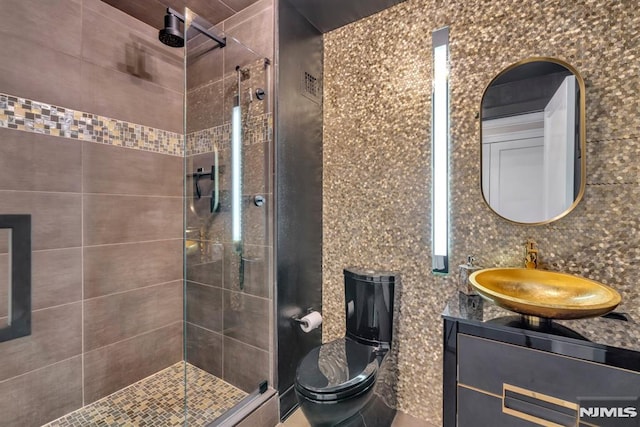 bathroom with vanity, tasteful backsplash, and tiled shower