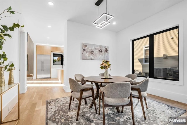 dining space featuring light wood-type flooring