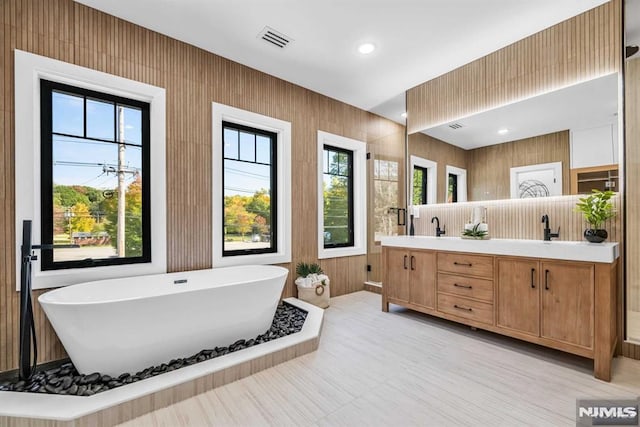 bathroom with vanity and a bath