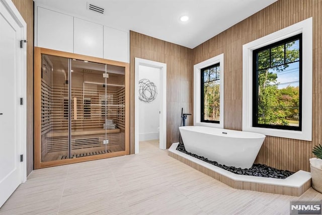 bathroom featuring tile patterned flooring and a bathtub