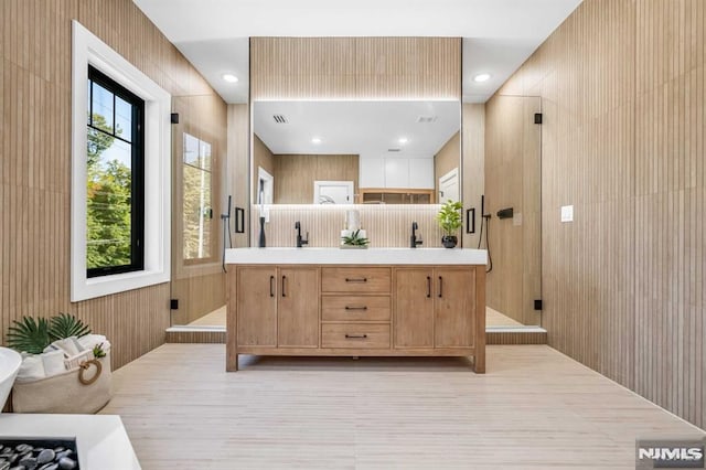 bathroom with an enclosed shower and vanity