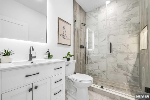 bathroom featuring vanity, toilet, and walk in shower