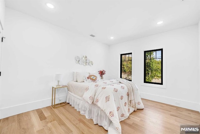 unfurnished bedroom with hardwood / wood-style flooring