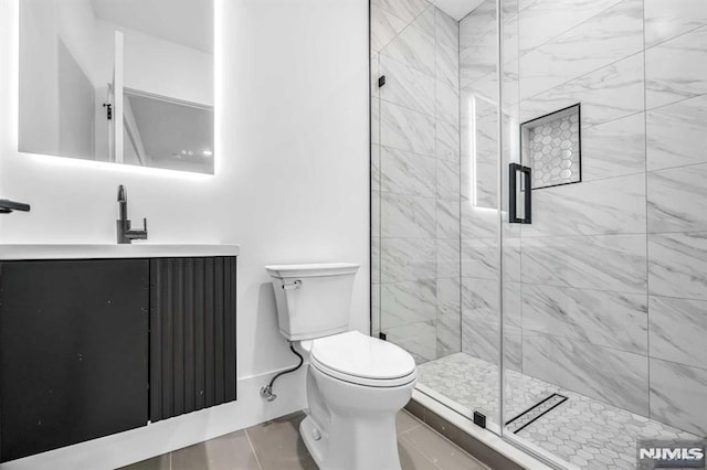 bathroom with vanity, a shower with shower door, and toilet