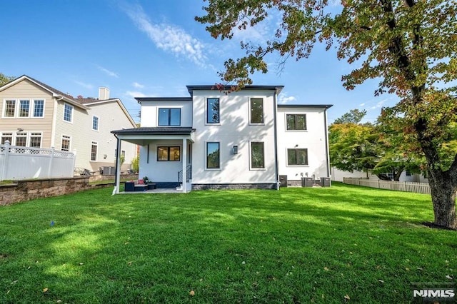 back of house featuring a patio area, central AC unit, and a lawn