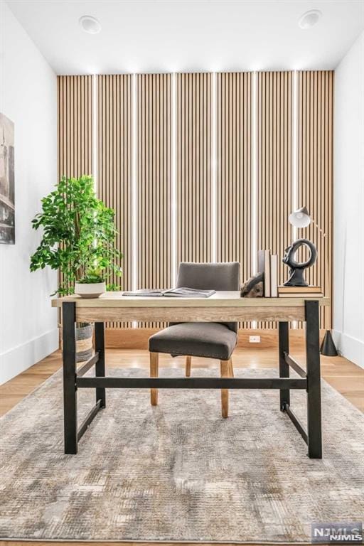 home office with wood-type flooring