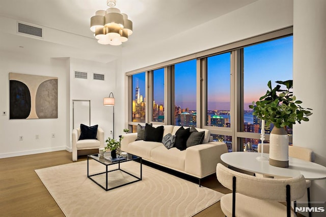 living room featuring an inviting chandelier and hardwood / wood-style floors