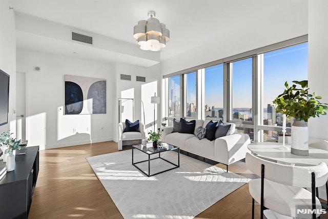 living room featuring an inviting chandelier and light hardwood / wood-style floors