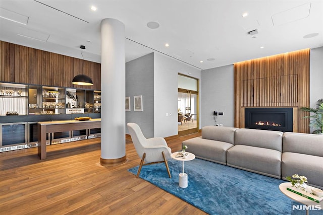 living room featuring bar and hardwood / wood-style floors