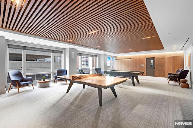 game room with a tray ceiling, wood ceiling, pool table, and carpet