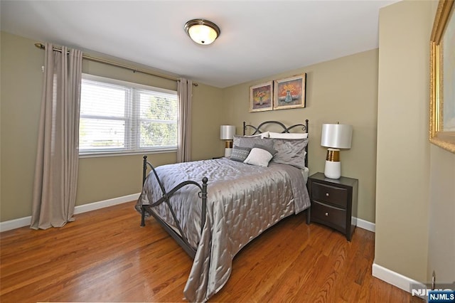 bedroom with hardwood / wood-style floors