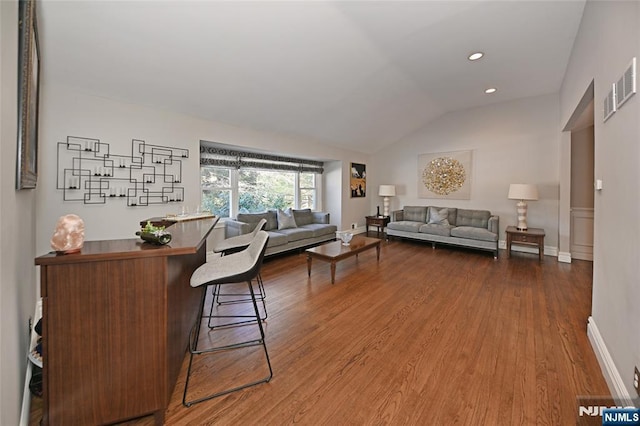 living room with wood-type flooring and lofted ceiling