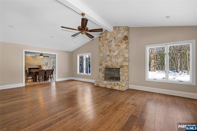 unfurnished living room featuring wood-type flooring, vaulted ceiling with beams, ceiling fan, and a fireplace