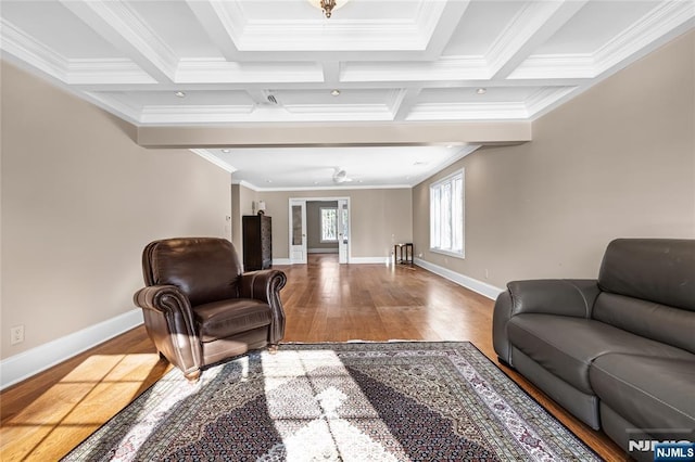 living room with beamed ceiling, coffered ceiling, and hardwood / wood-style floors