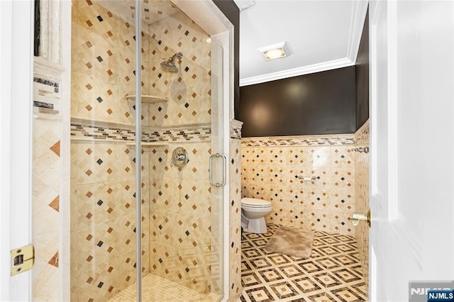 bathroom featuring tile walls, ornamental molding, toilet, and walk in shower