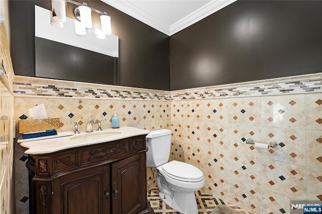 bathroom featuring ornamental molding, toilet, tile walls, and vanity