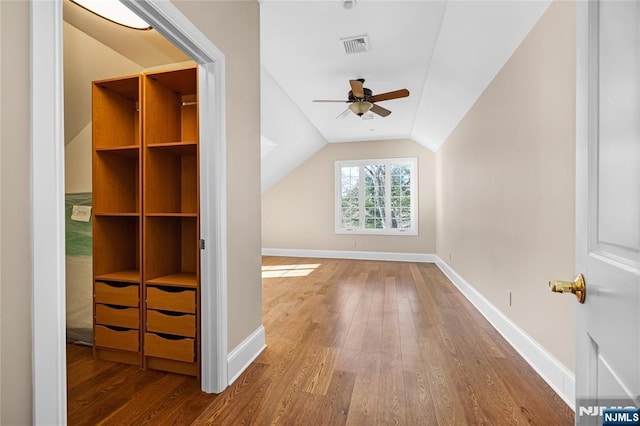 additional living space with ceiling fan, vaulted ceiling, and hardwood / wood-style floors