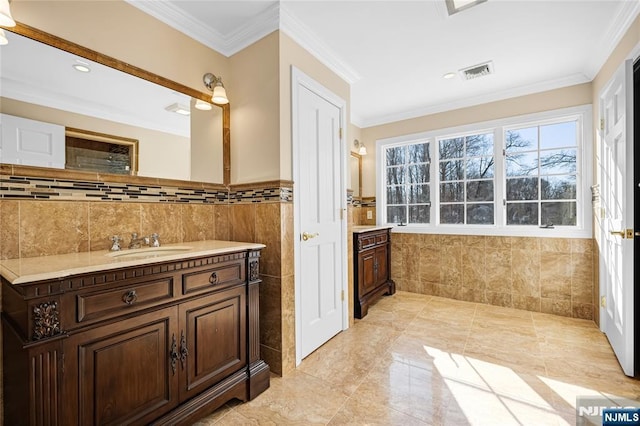 bathroom with ornamental molding, vanity, and tile walls