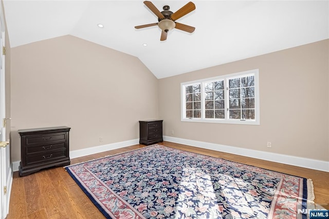 bedroom with ceiling fan, lofted ceiling, and light hardwood / wood-style flooring