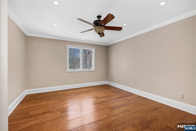 spare room with hardwood / wood-style flooring, crown molding, and ceiling fan